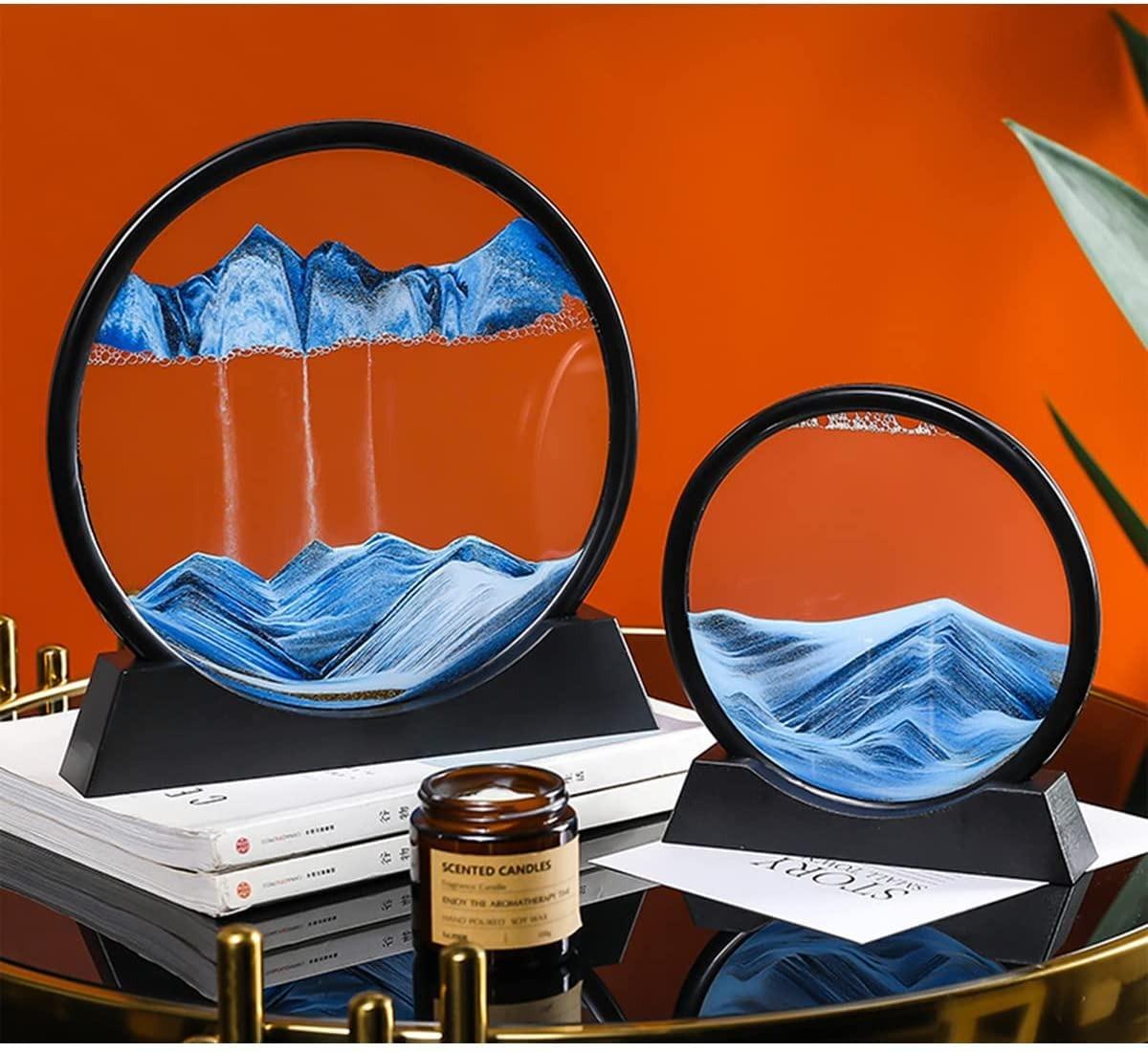 Two decorative items resembling mountain landscapes on a reflective surface with an orange background.